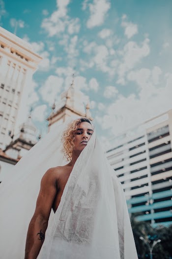 Low Angle Photo of Man Covered With White Blanket