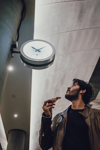 Low Angle Photo of Man Looking Towards the Clock