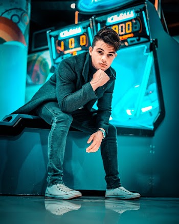 Low-Angle Photo of Man Sitting on Arcade Machine