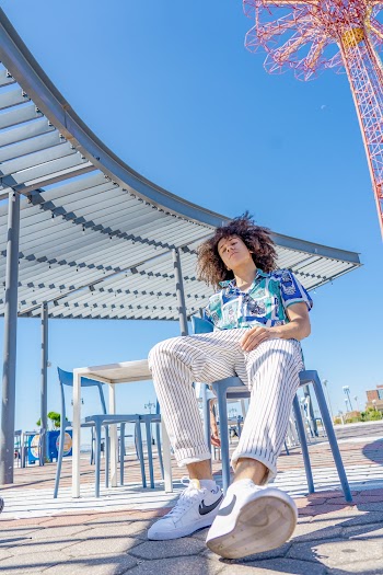 Low-Angle Photo of Man Sitting on Chair