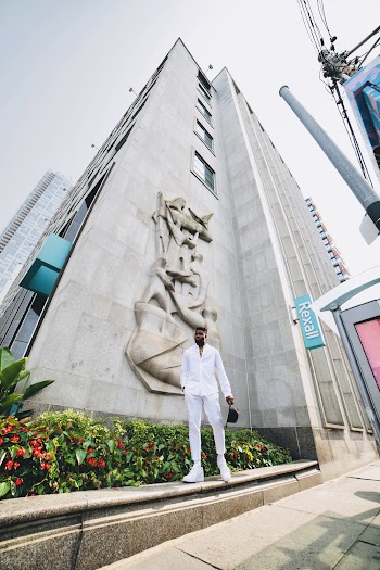 Low Angle Photo Of Man Standing Near Building