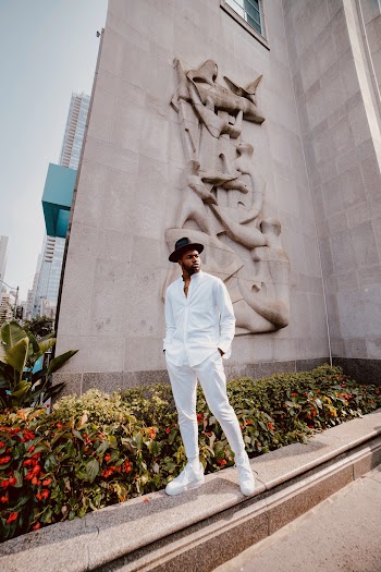 Low Angle Photo Of Man Standing Near Building
