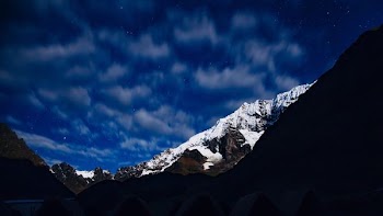 low-angle photo of mountain covered snow