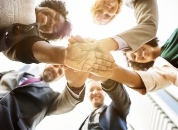 Low Angle Photo of People Doing Huddle Up