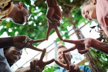 Low Angle Photo of People Doing Star Shape