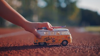 Low-Angle Photo of Person's Hand Holding a Miniature Toy Car