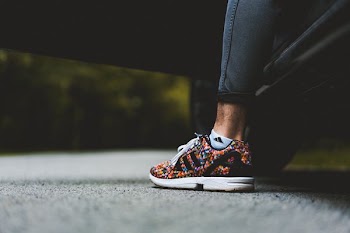 low-angle photo of person wearing multicolored sneaker