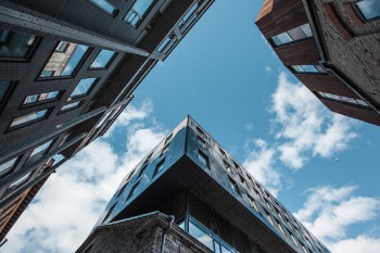 Low Angle Photo of Skyscrapers Under White Cloudy Sky