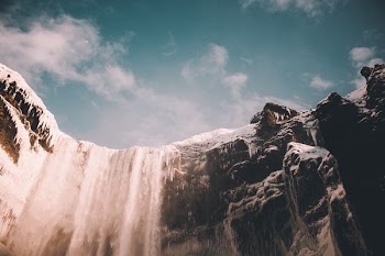 low angle photo of waterfalls at daytime