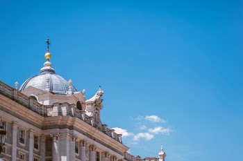 Low-angle Photo of White Concrete Palace Under Clear Blue Sky