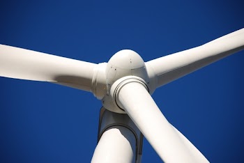 Low Angle Photo of White Wind Turbine Under Deep Blue Sky