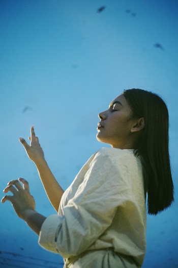Low Angle Photo of Woman Closing Her Eye