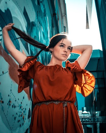 Low-Angle Photo of Woman Holding Her Hair