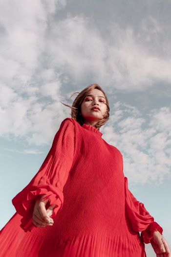 Low Angle Photo of Woman in Red Long-sleeved Dress Posing