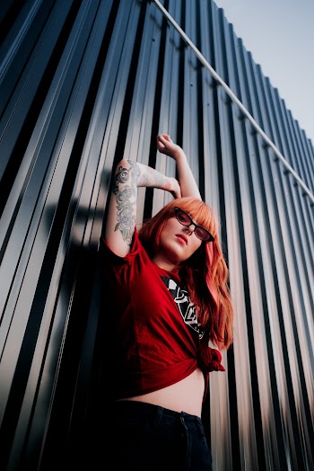 Low Angle Photo of Woman in Red T-shirt Posing