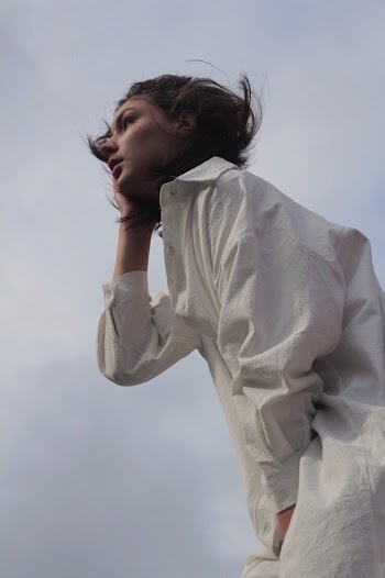 Low Angle Photo of Woman in White Dress Shirt Posing