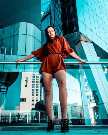 Low-Angle Photo of Woman Leaning on Handrail