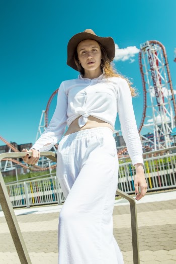 Low Angle Photo of Woman Leaning on Metal Frame