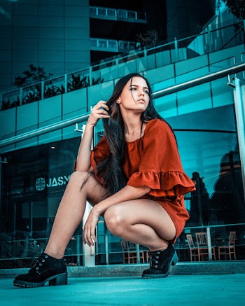 Low-Angle Photo of Woman Posing Near Handrail