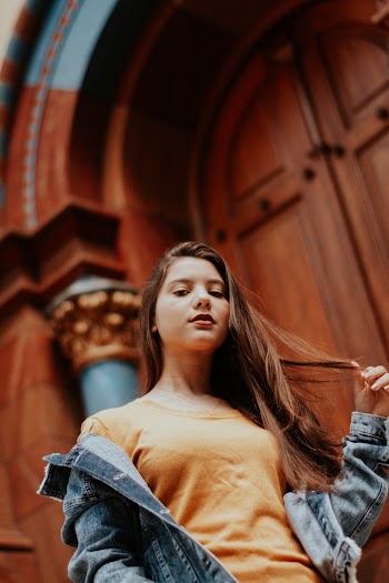 Low Angle Photo of Woman Posing While Looking Down