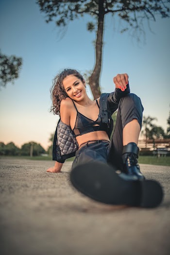 Low Angle Photo of Woman Sitting on Ground
