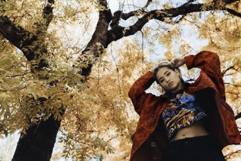 Low-Angle Photo of Woman Standing Near Tree