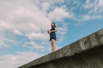 Low Angle Photo of Woman Standing on Bridge