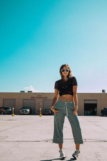 low angle photo of woman standing on road
