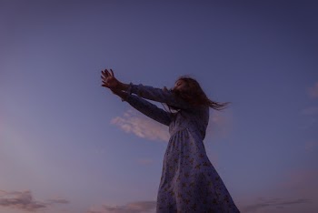 Low Angle Photo of Woman Wearing Floral Dress