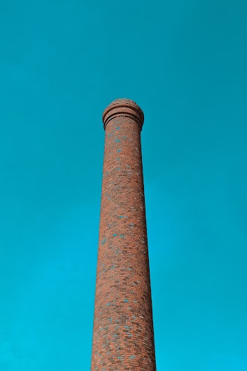 Low-angle Photography of a Brown Tower Under a Calm Blue Sky
