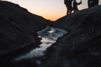 Low-angle Photography of A Stream Under Gray Sky