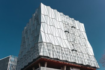 Low-angle Photography of Abstract-styled White Building Under Calm Blue Sky