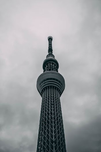 low-angle photography of black concrete tower