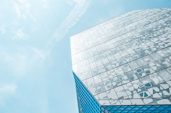 Low-angle Photography of Blue Laminated Glass Building Under Calm Blue Sky