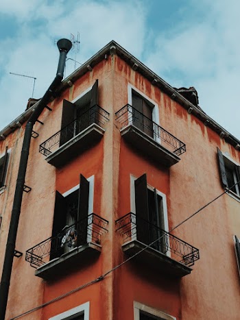 Low Angle Photography of Brown Concrete Building with Balconies