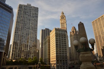 Low Angle Photography of Brown Concrete High Rise Building Beside Buildings Under White and Blue Sky