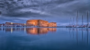 Low-angle Photography of Brown Structure Near Boats