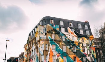 low-angle photography of building with art painting