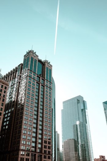 low angle photography of curtain wall buildings taken under clear sky
