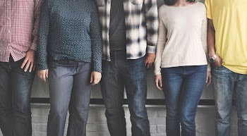 low-angle photography of five person wearing blue and black denim jeans