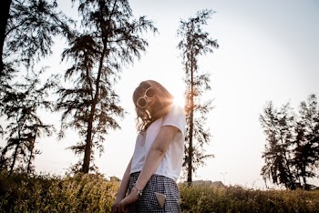 Low-angle Photography of Girl Wearing White T-shirt in Front of Trees