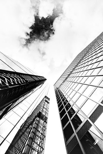 low-angle photography of glass buildings
