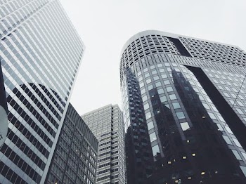 low-angle photography of glass window buildings