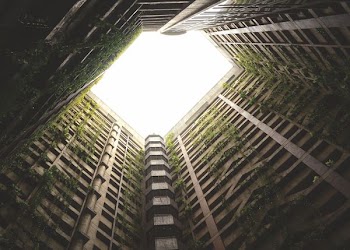 low angle photography of gray concrete high rise building