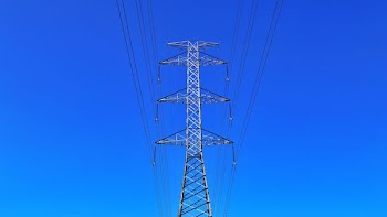 low angle photography of gray electric tower