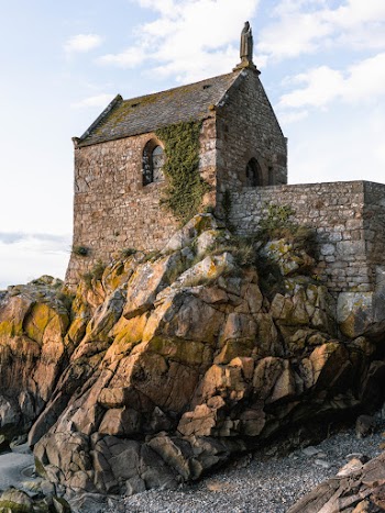 Low-angle Photography of Gray Stone House on Boulder