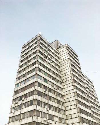 low-angle photography of grey high-rise building