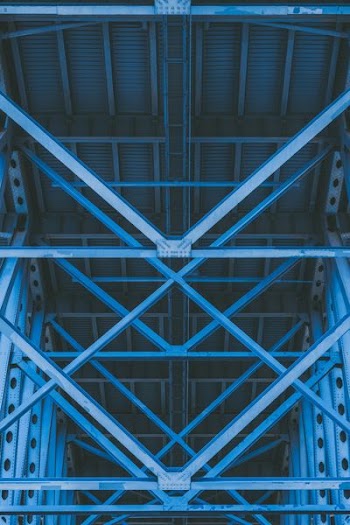 low-angle photography of grey metal beams and roof