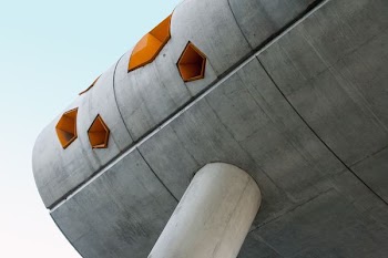 low angle photography of grey structure under blue sky during daytime