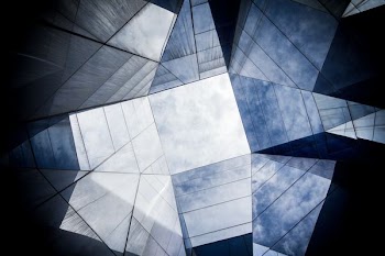 low angle photography of mirror and blue sky